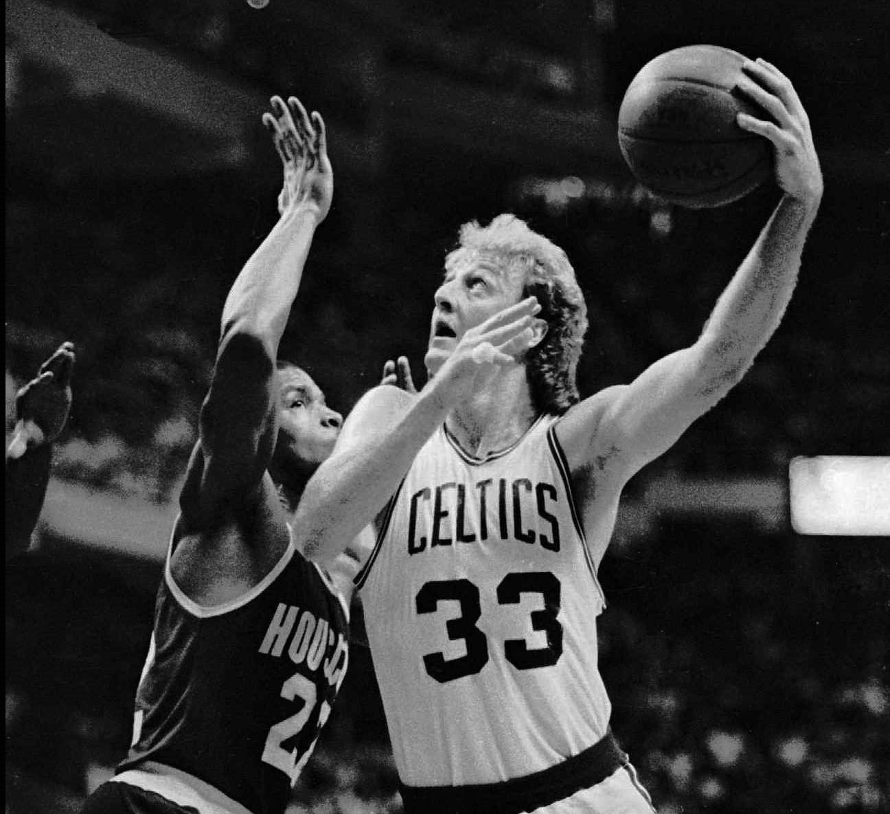 Boston Celtics forward Larry Bird motors past Houston Rockets Rodney McCray.