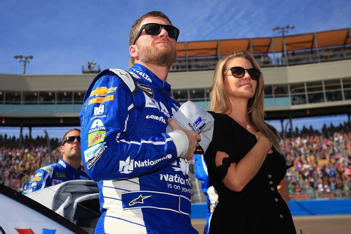 Dale Earnhardt Jr., driver of the #88 Nationwide Chevrolet, and his wife Amy stand during the national anthem prior to the Monster Energy NASCAR Cup Series Can-Am 500