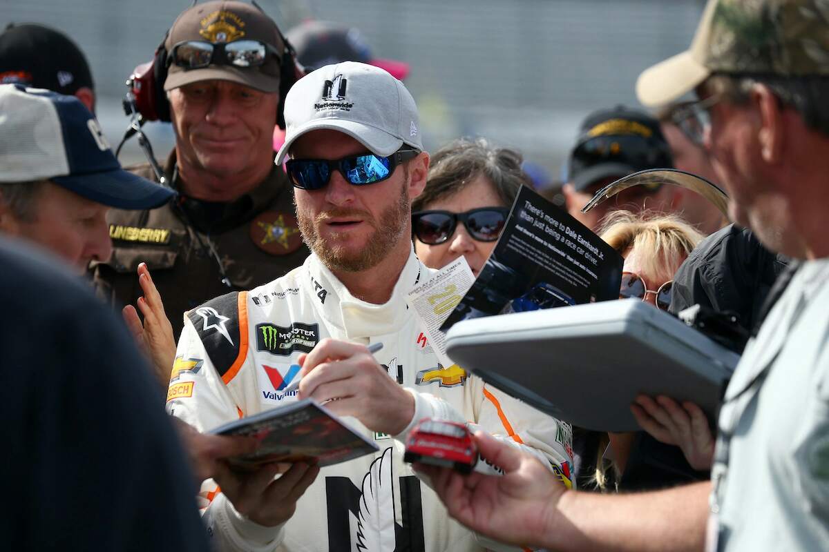 Driver of the #88 Nationwide Chevrolet, Dale Earnhardt Jr. signs autographs for fans