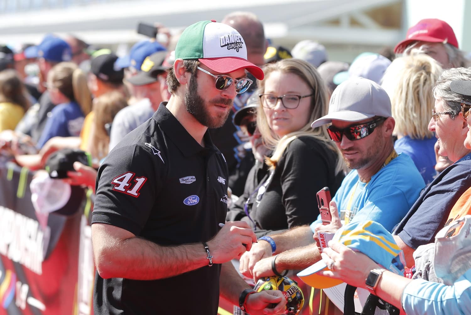 Daniel Suarez signs autographs during the drivers meeting prior to the NASCAR Cup Series Ford EcoBoost 400 at Homestead Speedway on Nov. 17, 2019. | Brian Lawdermilk/Getty Images