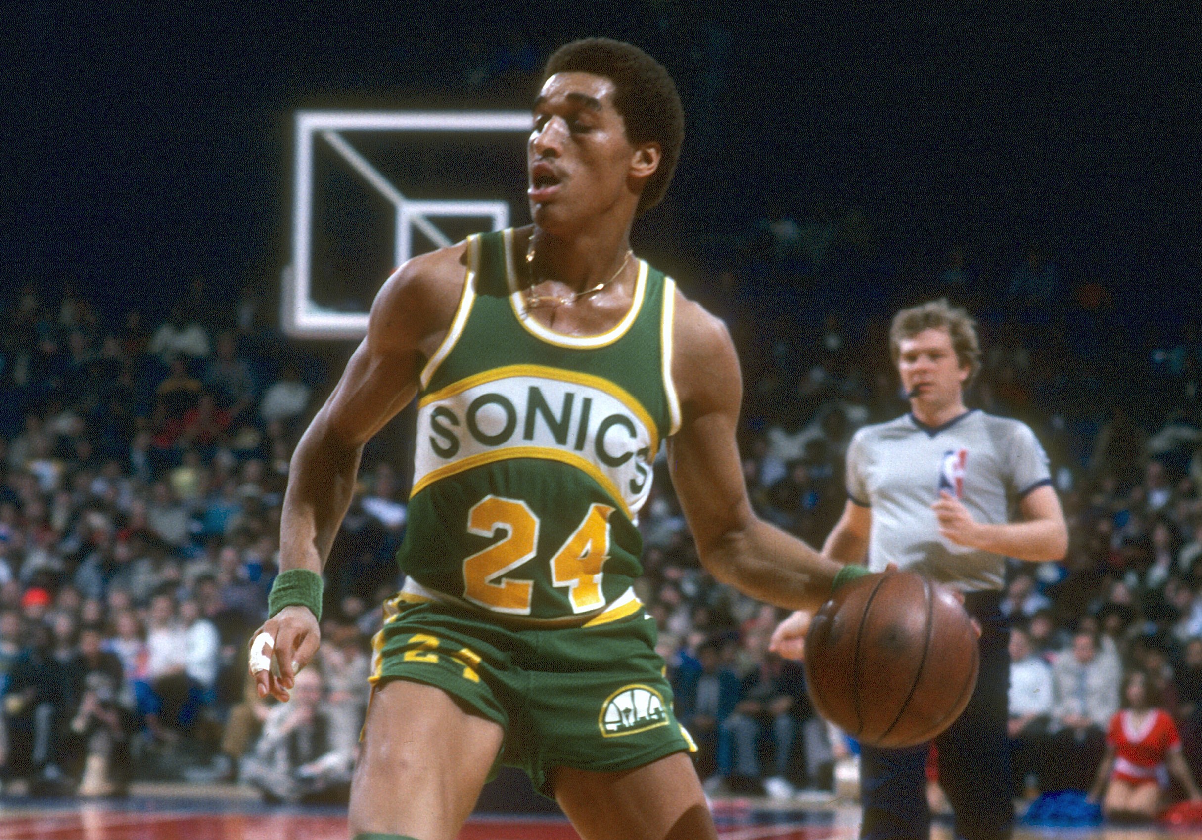Dennis Johnson of the Seattle Supersonics dribbles the ball against the Washington Bullets.