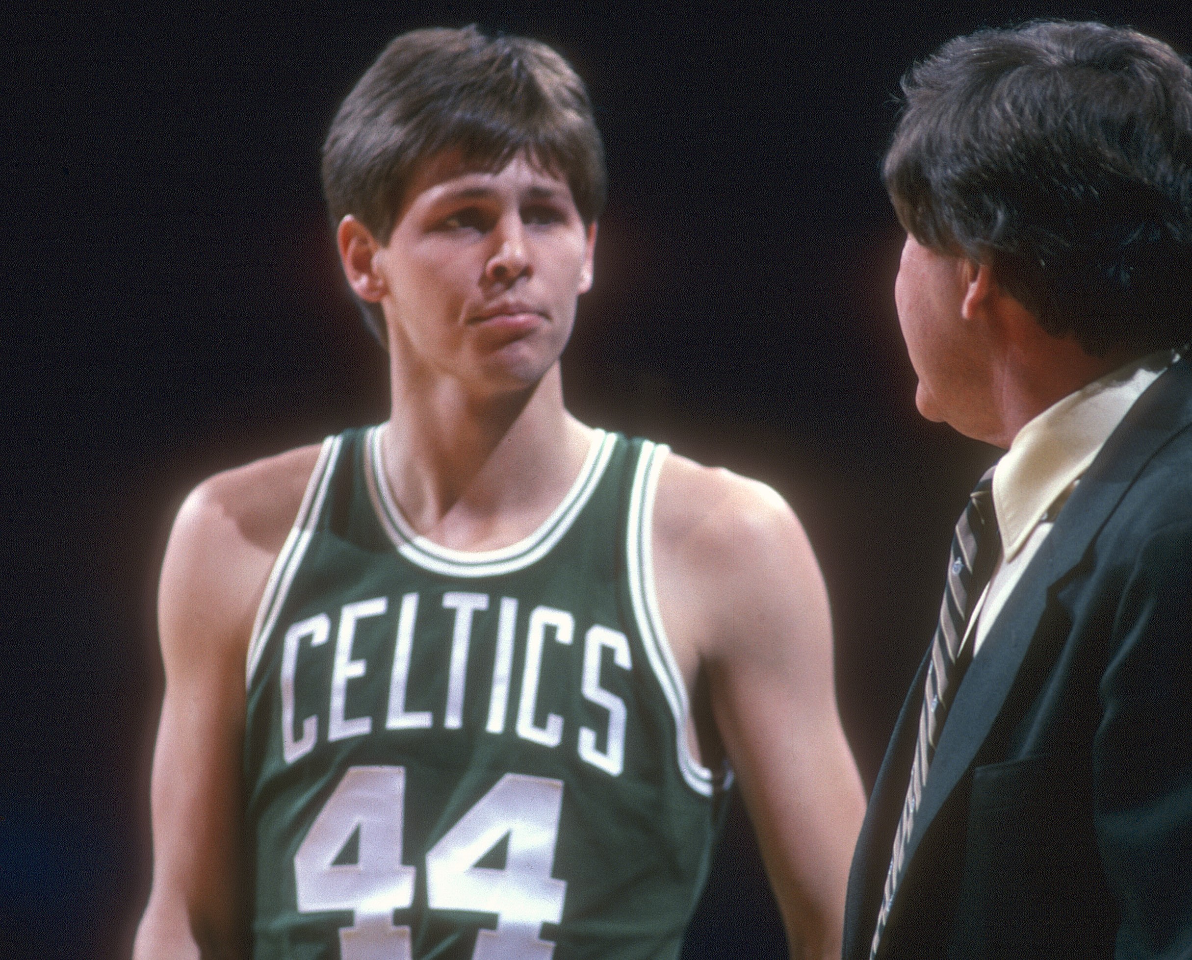 Danny Ainge of the Boston Celtics talks with head coach Bill Fitch.