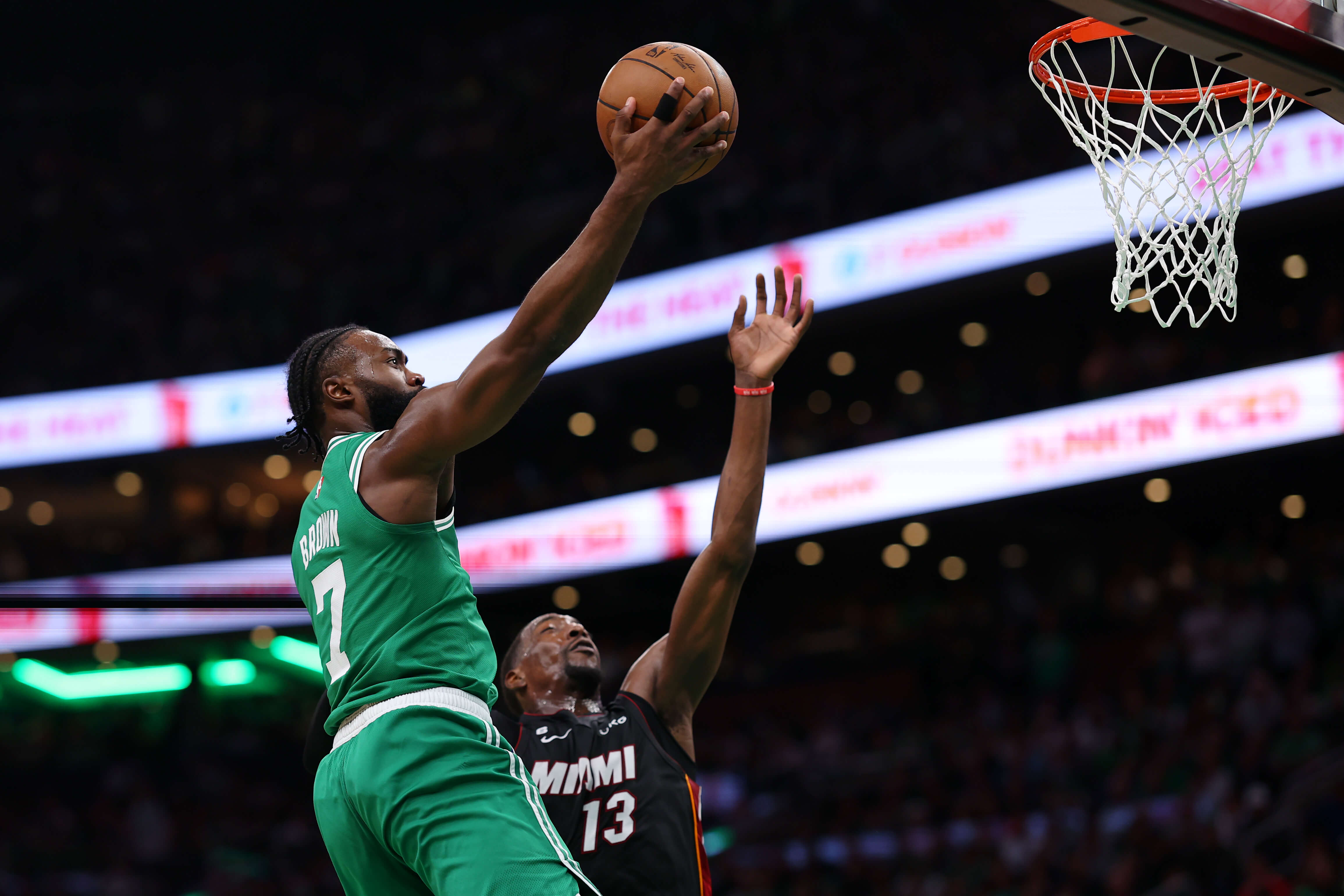 Jaylen Brown of the Boston Celtics drives to the basket against Bam Adebayo of the Miami Heat.