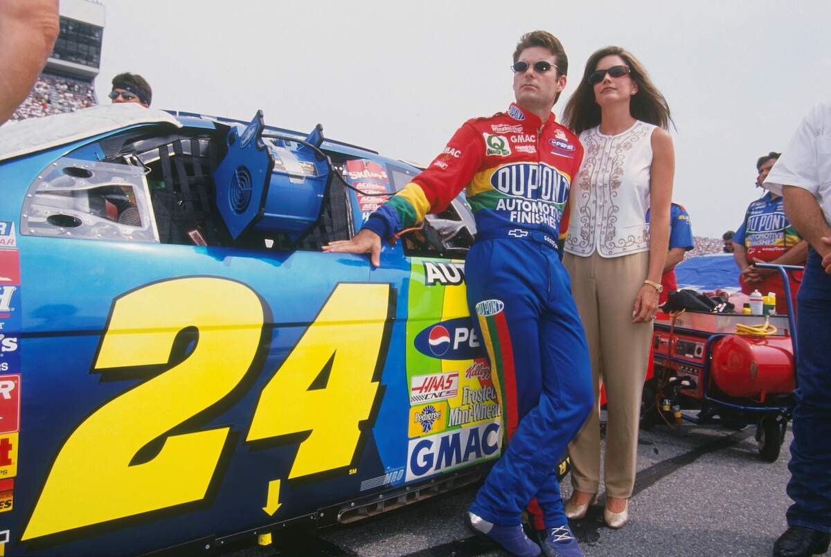 NASCAR driver Jeff Gordon stands with his wife, Brooke Gordon, next to the Dupont #24 car during the Daytona 500 at the Daytona Speedway