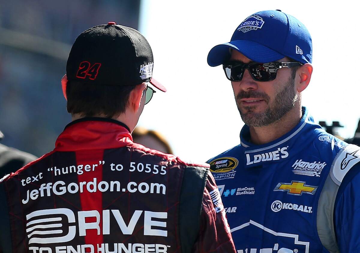 Jimmie Johnson, driver of the #48 Lowe's Chevrolet, talks to Jeff Gordon, driver of the #24 Drive To End Hunger Chevrolet, after qualifying for the 57th Annual Daytona 500 at Daytona International Speedway on February 15, 2015