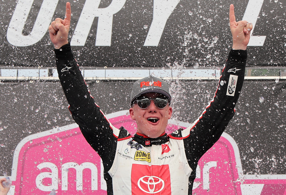 John Hunter Nemechek throws his hands up in the air to celebrate