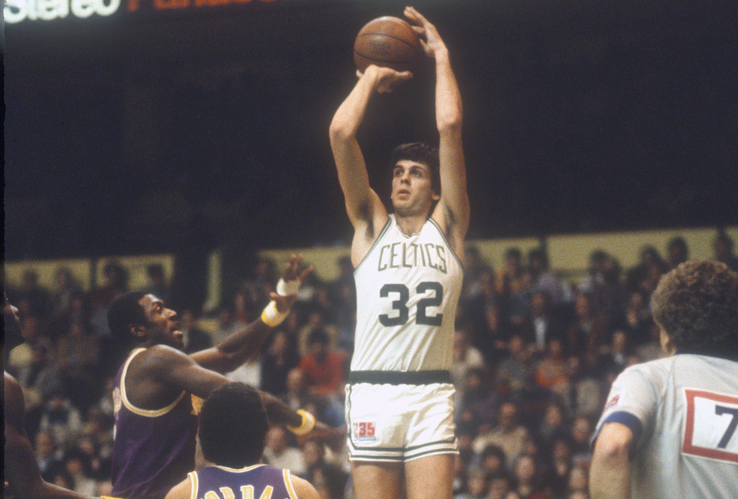 Kevin McHale of the Boston Celtics shoots over Bob McAdoo of the Los Angeles Lakers.
