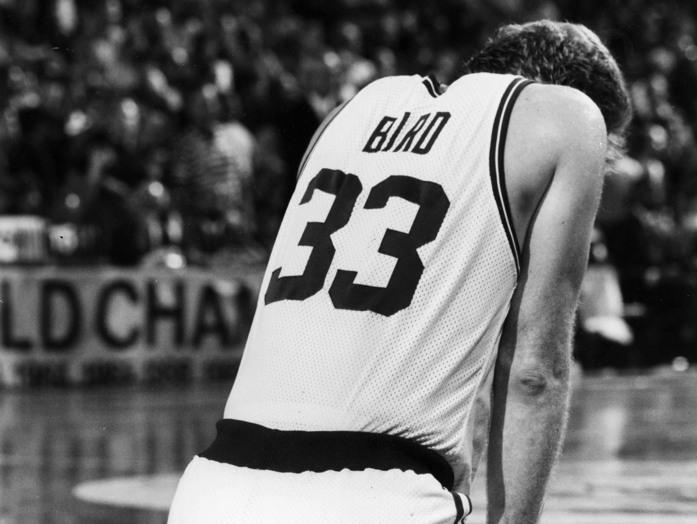 Boston Celtics Larry Bird kneels down after being injured during a game against the Indiana Pacers at the Boston Garden, May 5, 1991.
