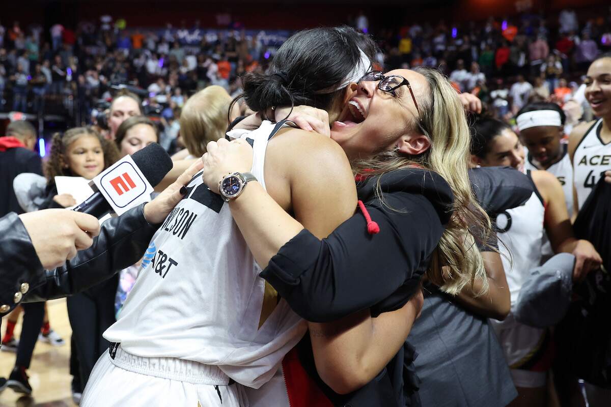 A'ja Wilson of the Las Vegas Aces celebrates with head coach Becky Hammon after winning the 2022 WNBA Finals