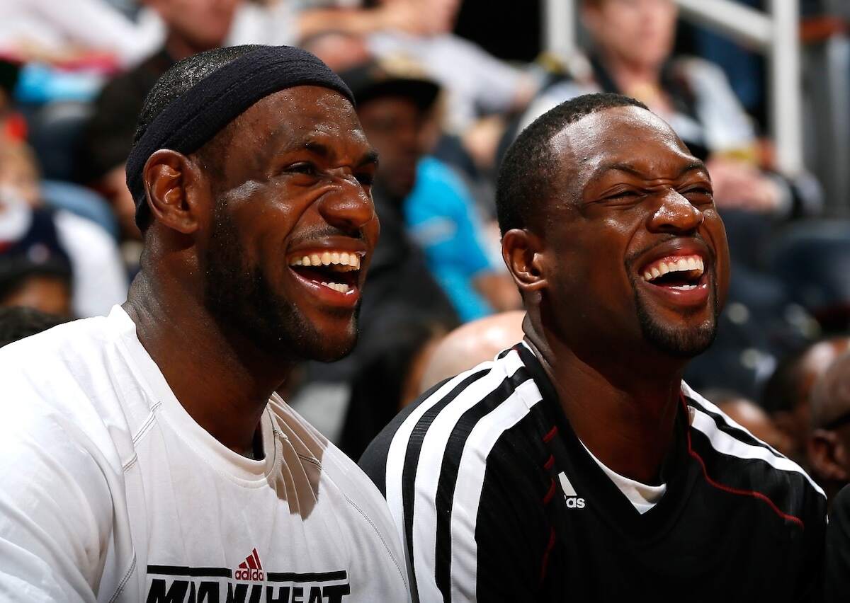 LeBron James (L) and Dwyane Wade of the Miami Heat laugh together on the bench