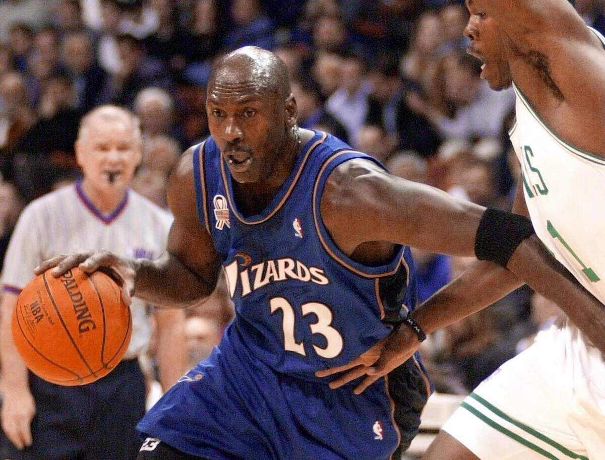 Washington Wizards player Michael Jordan dribbles down the hardwood