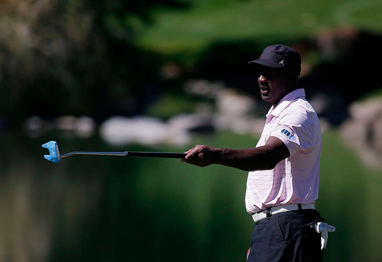 NBA legend Michael Jordan gestures with his putter on the golf course.