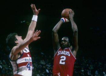 Moses Malone of the Philadelphia 76ers shoots over Jeff Ruland of the Washington Bullets.