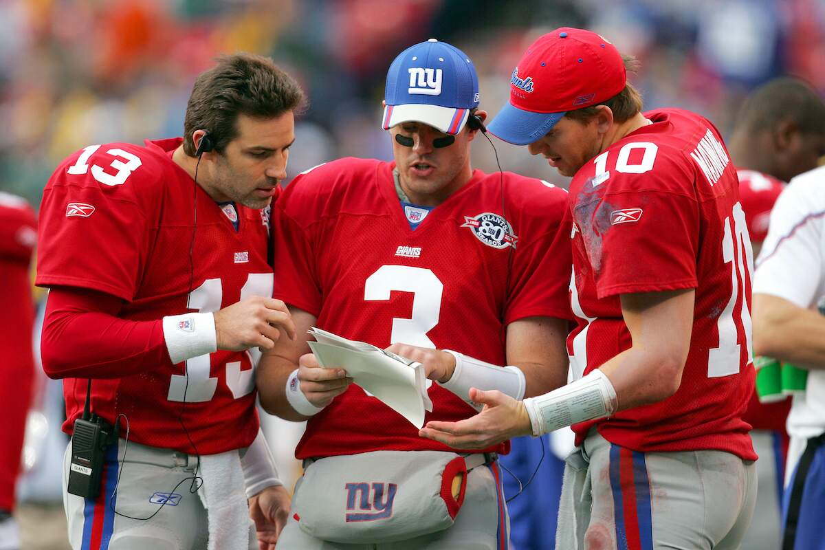 Quarterbacks Kurt Warner, Jesse Palmer, and Eli Manning of the New York Giants study game formations in 2004