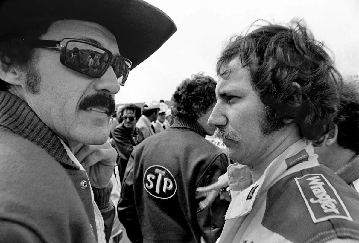 NASCAR race car driver Richard Petty, left, talks with fellow driver Dale Earnhardt Sr. prior to drivers' introductions at the 1982 Daytona 500