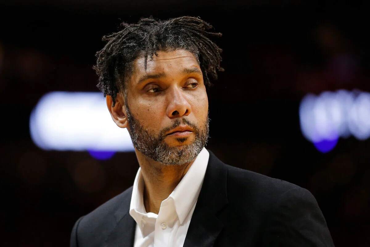 Retired Spurs player Tim Duncan wears a suit at an NBA game