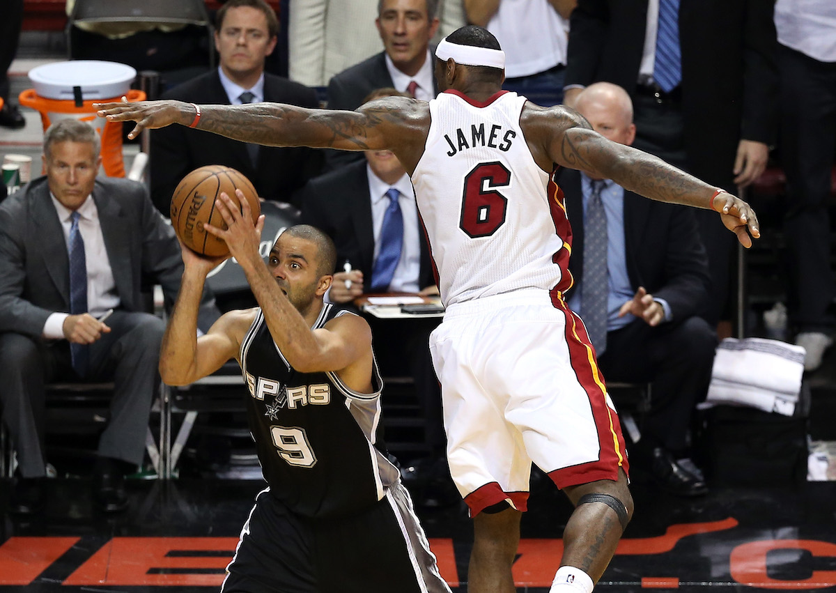 Tony Parker avoids LeBron James and prepares to launch a spinning jumper in Game 1 of the 2013 NBA Finals.