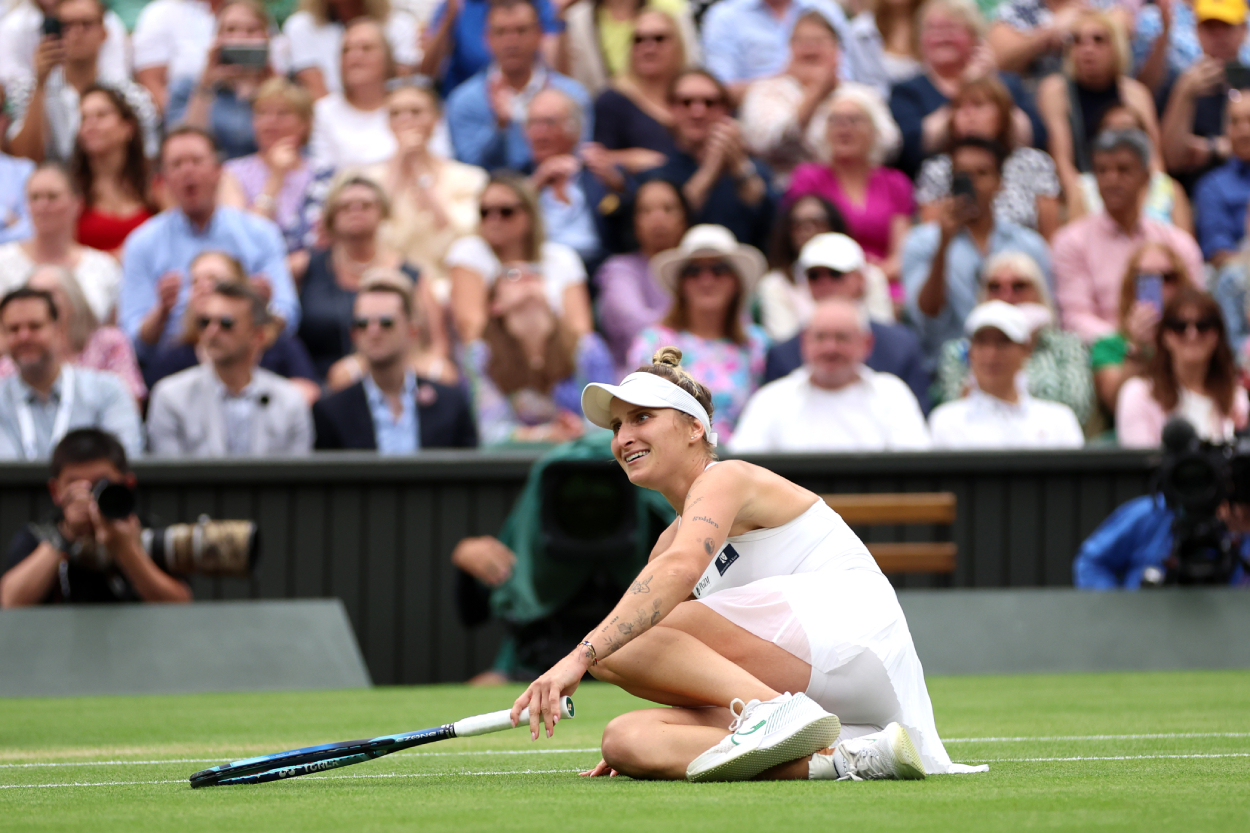Marketa Vondrousova of Czech Republic falls to the floor as she celebrates winning match point in the Women's Singles Final at Wimbledon.