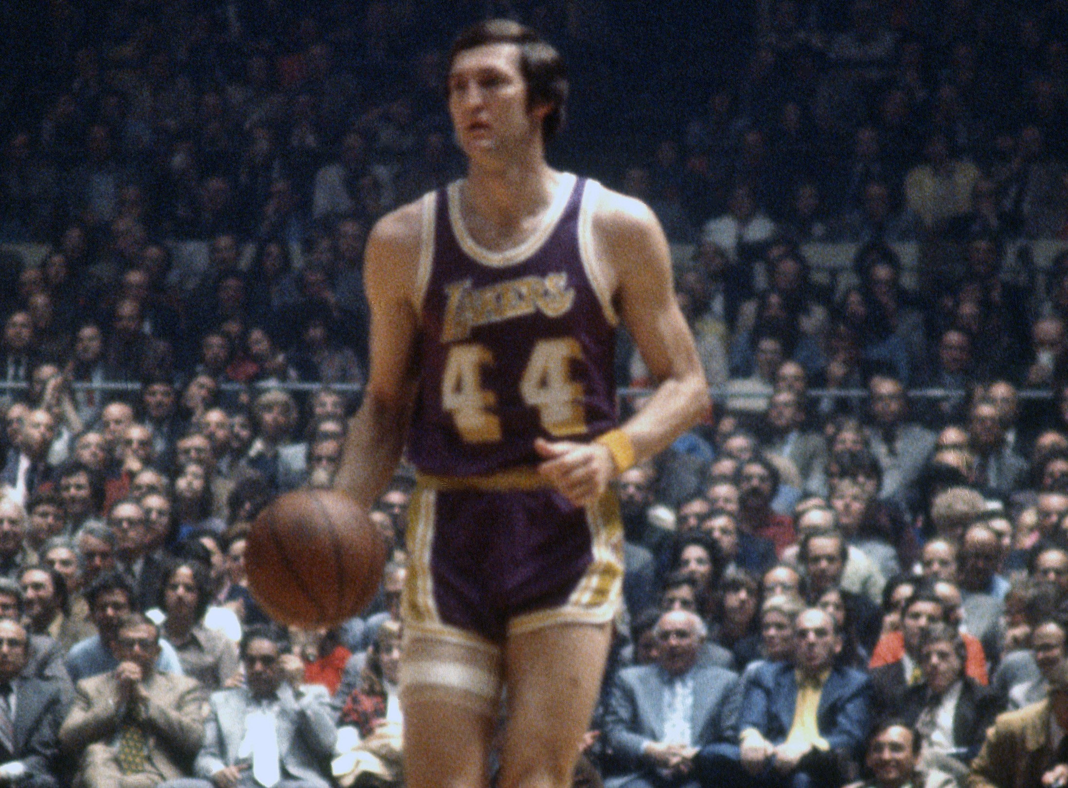 Jerry West of the Los Angeles Lakers dribbles the ball up court.