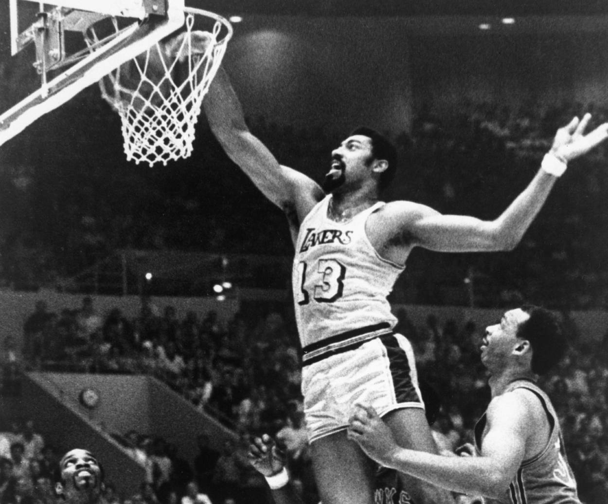 The Los Angeles Lakers center Wilt Chamberlain drives to the basket for a one-handed dunk.