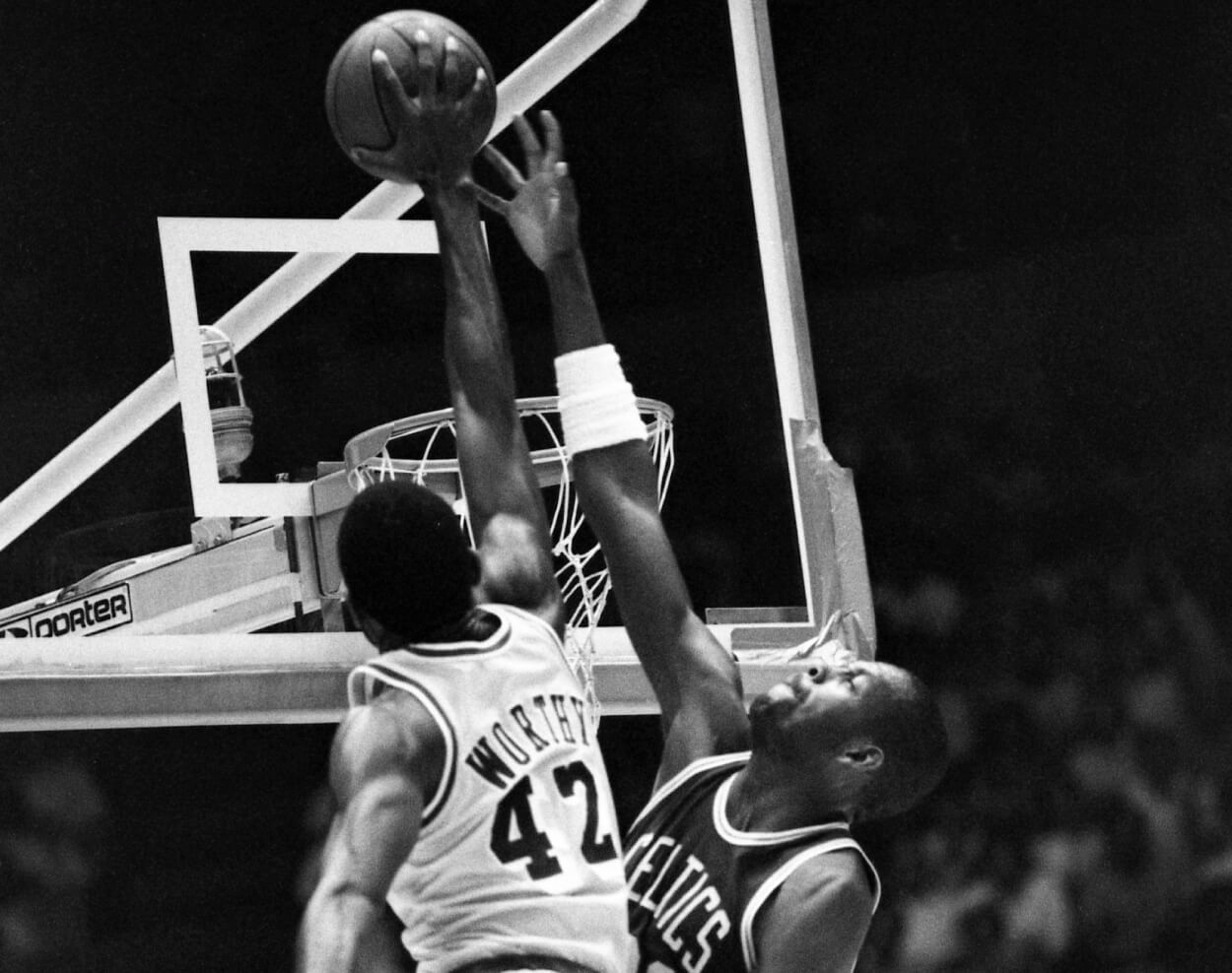 Los Angeles Lakers forward James Worthy dunks over Boston Celtics forward Cedric Maxwell.