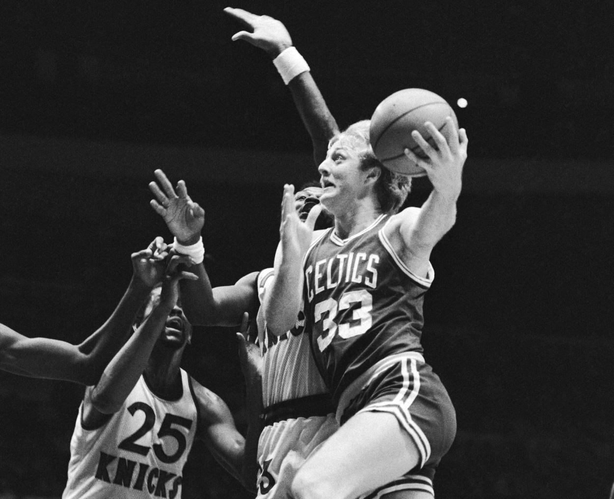 Larry Bird barrels past New York Knicks' Len Robinson.