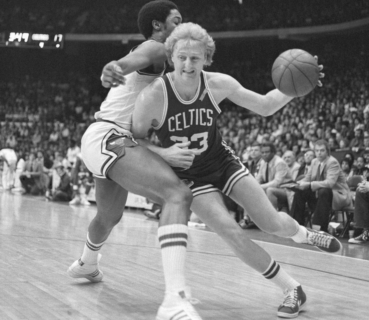 Driving to the basket, Boston Celtics forward Larry Bird puts a shoulder into David Greenwood of the Chicago Bulls.