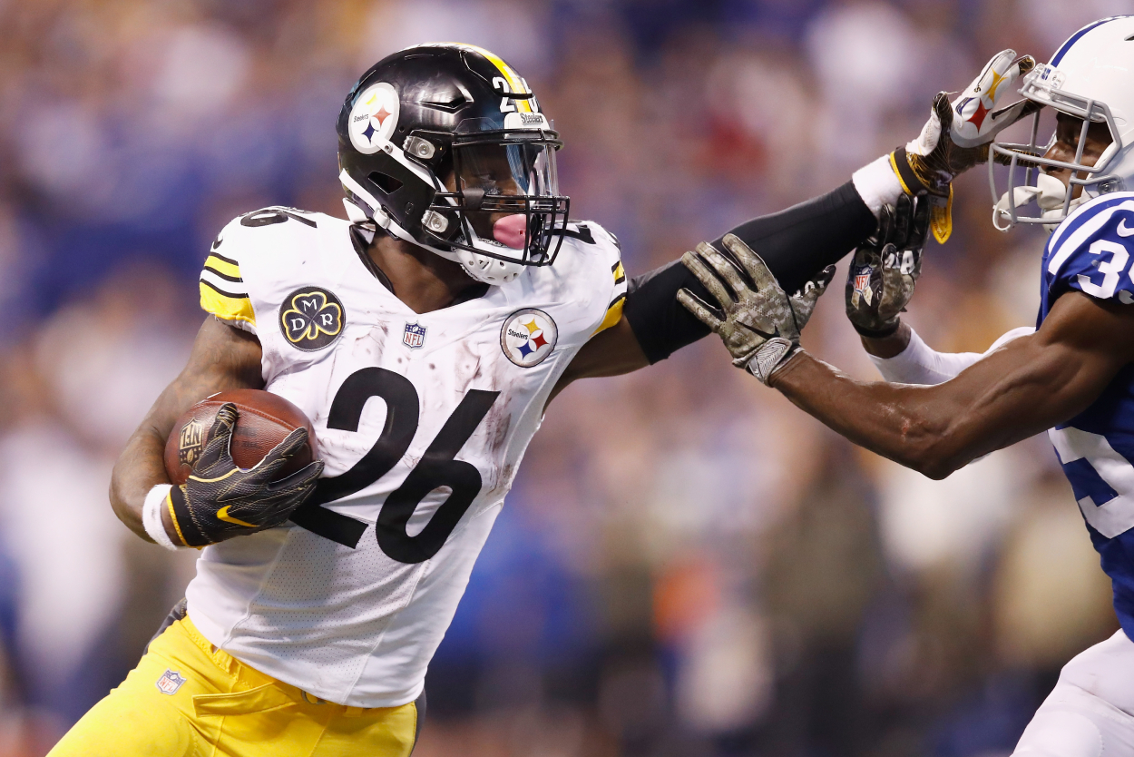Le'Veon Bell of the Pittsburgh Steelers stiff arms Pierre Desir of the Indianapolis Colts.