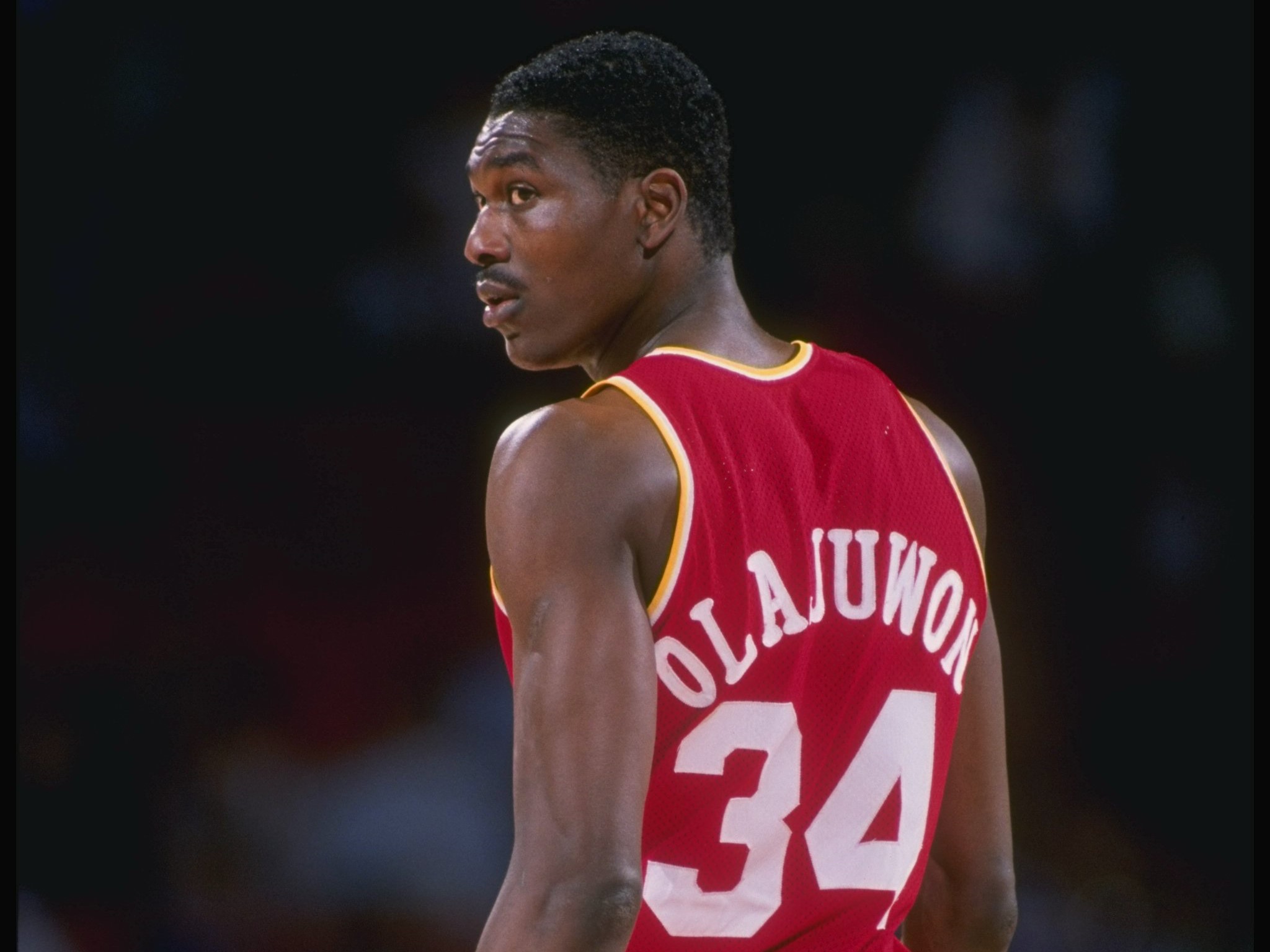 Center Hakeem Olajuwon of the Houston Rockets looks on.