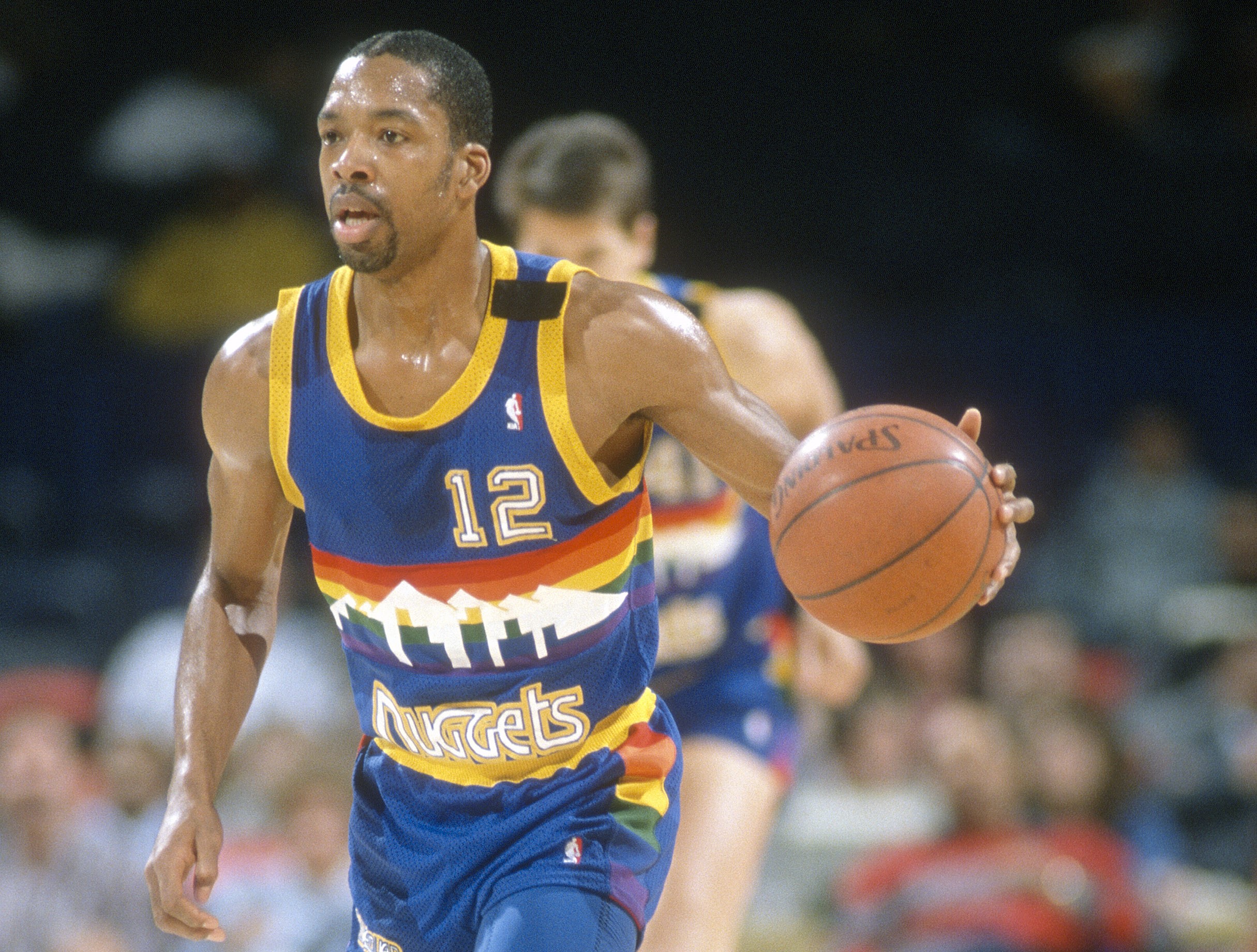Fat Lever of the Denver Nuggets dribbles up the court.