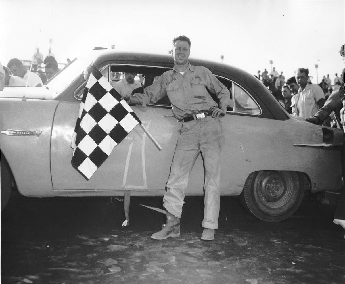 Jim Reed displays the checkered flag after winning the 1959 Southern 500