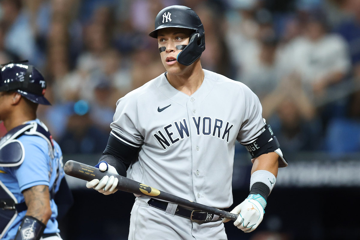 Aaron Judge looks at the field while holding his bat.