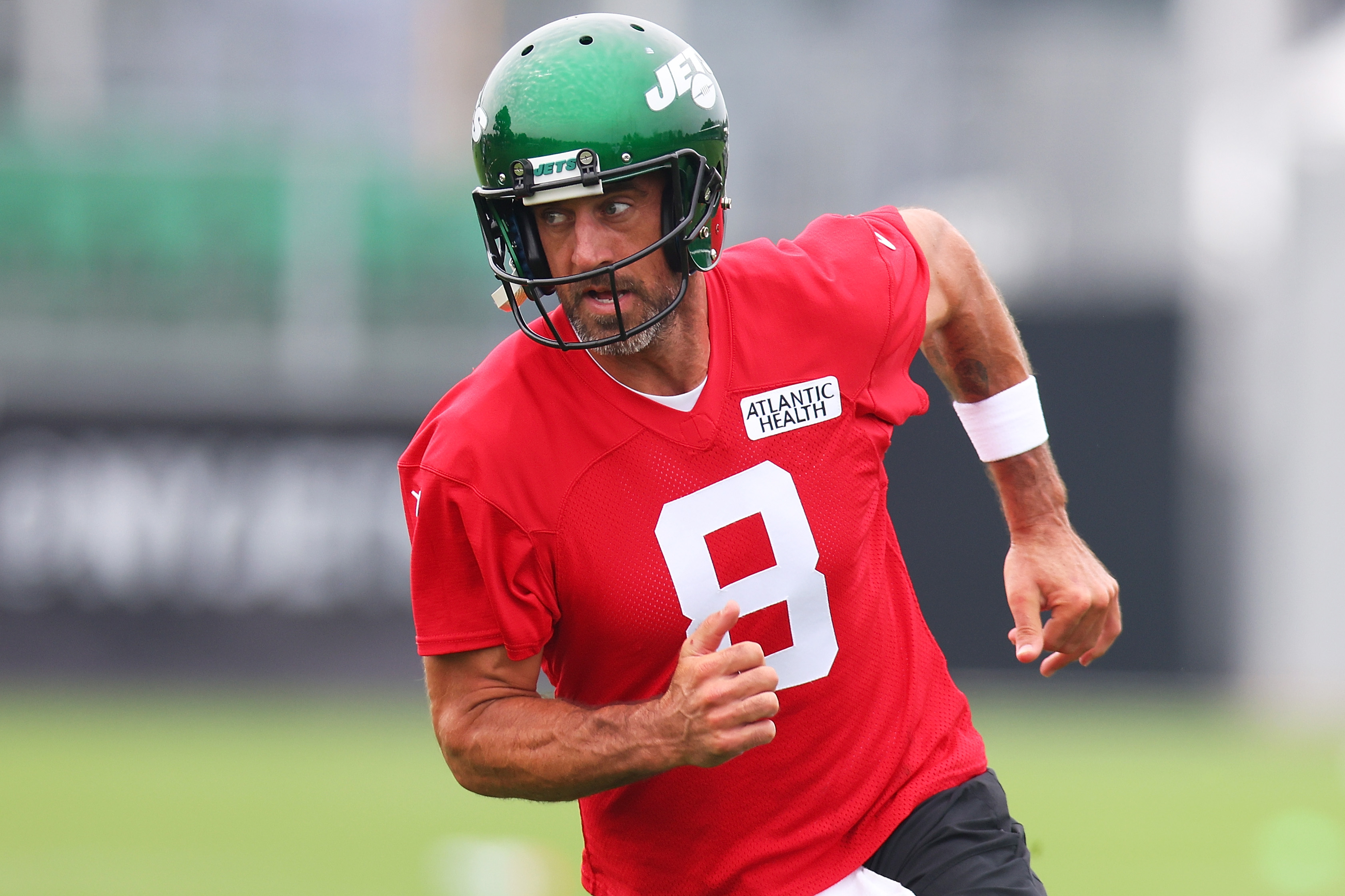 Aaron Rodgers of the New York Jets run drills during training camp.