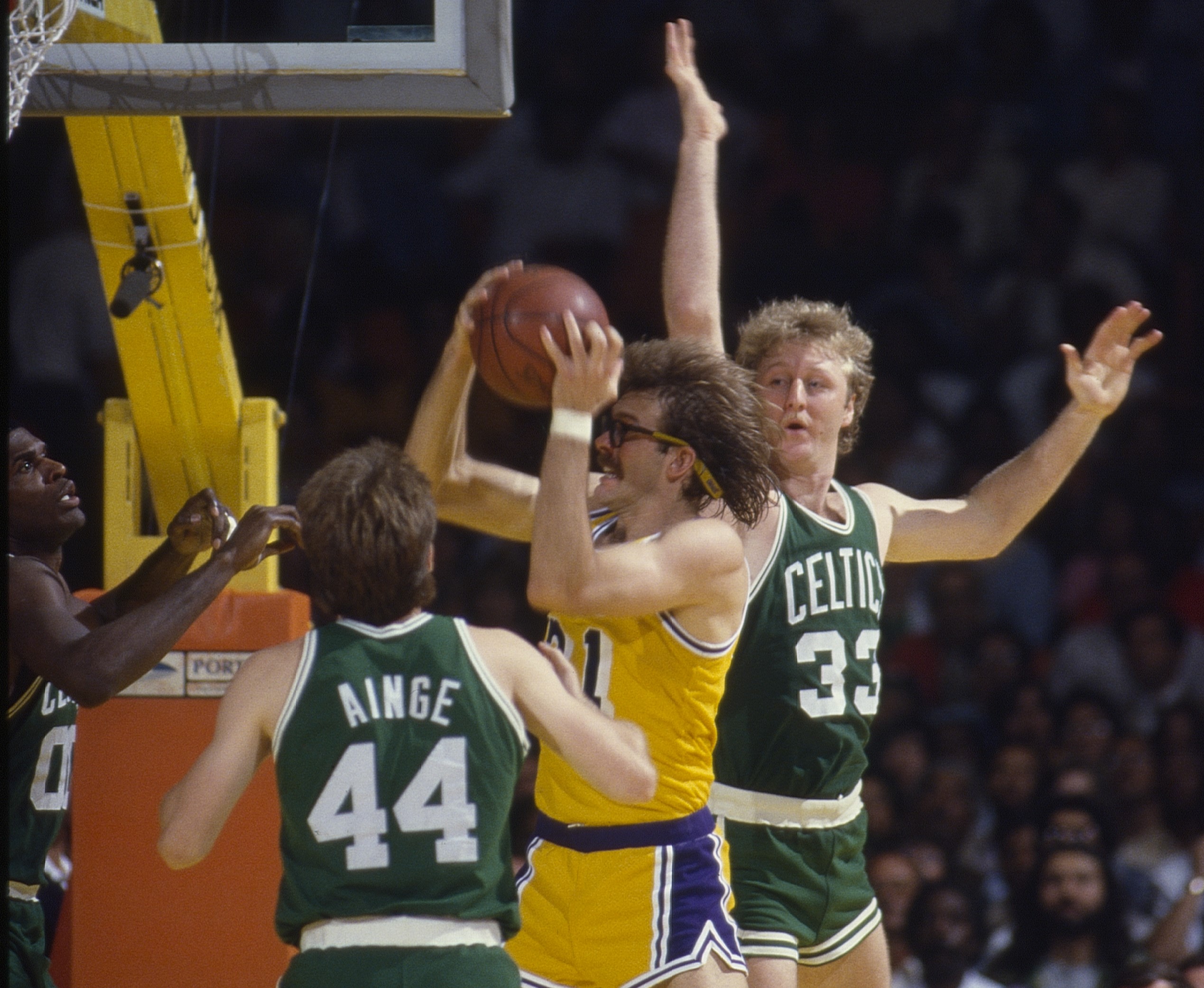 Los Angeles Lakers Kurt Rambis gets a rebound over Boston Celtics Larry Bird and Danny Ainge.