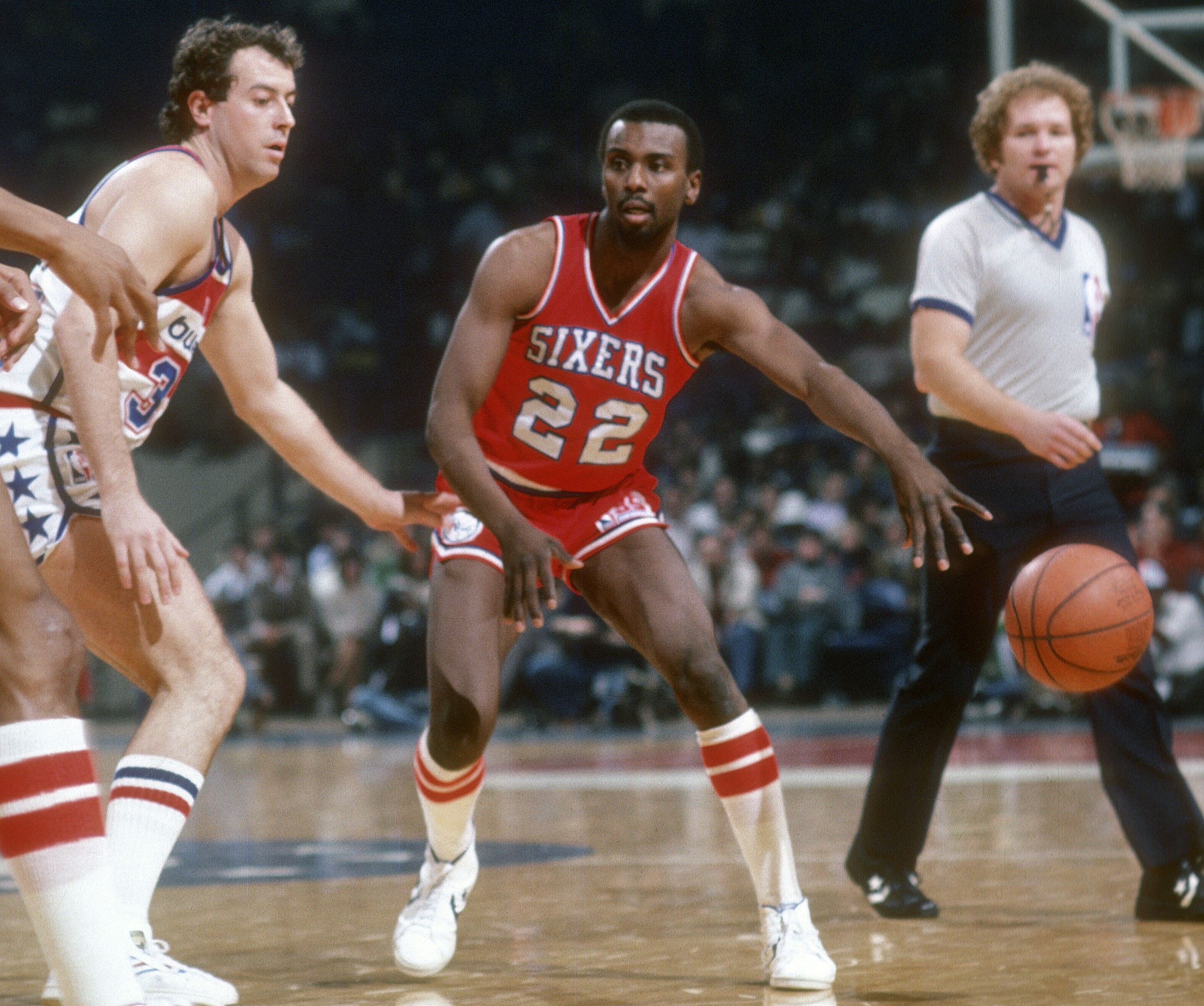 Andrew Toney of the Philadelphia 76ers passes the ball against the Washington Bullets.