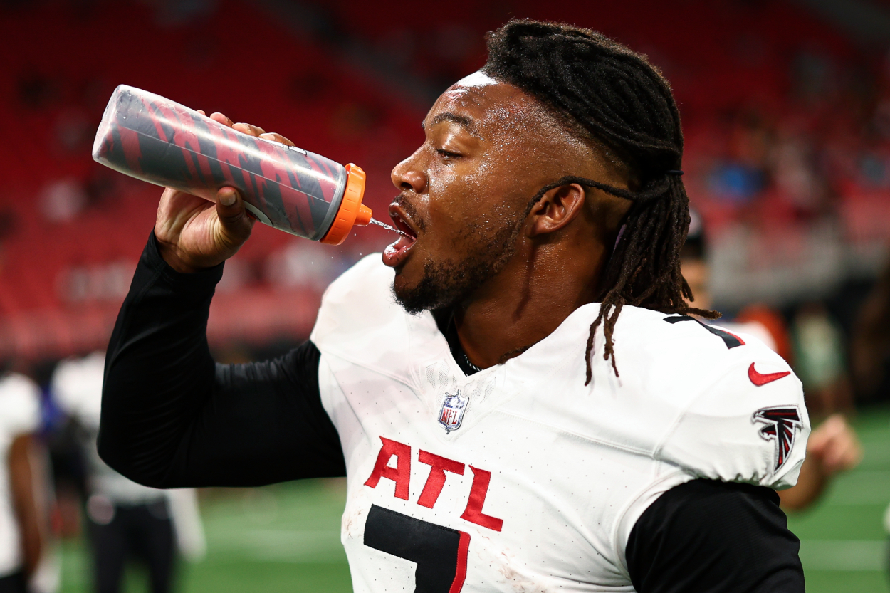Bijan Robinson of the Atlanta Falcons drinks from a Gatorade bottle.