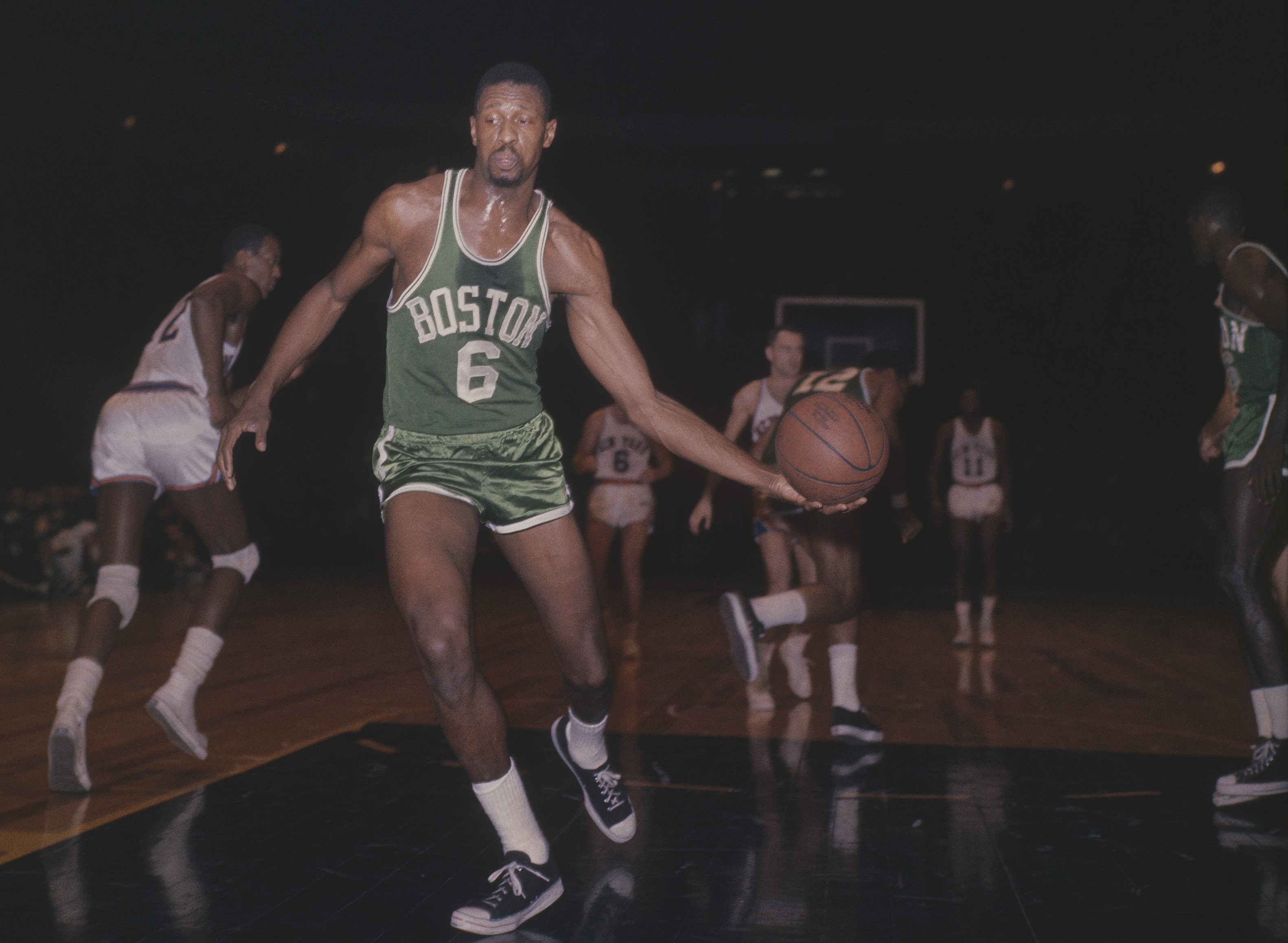 Bill Russell of the Boston Celtics takes the ball after a New York Knicks score circa the 1960s.