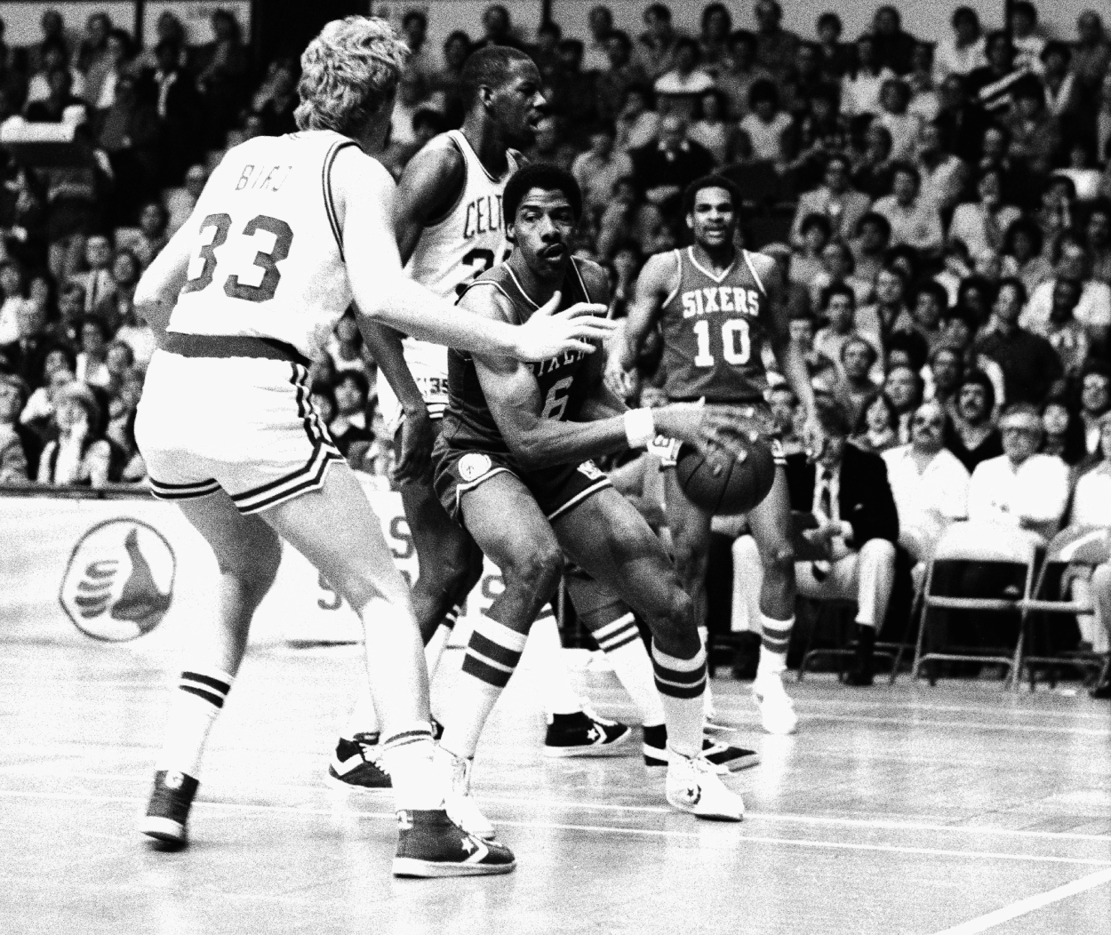 Julius Erving of the Philadelphia 76ers (center) finds his way blocked by Boston Celtics forward Larry Bird.