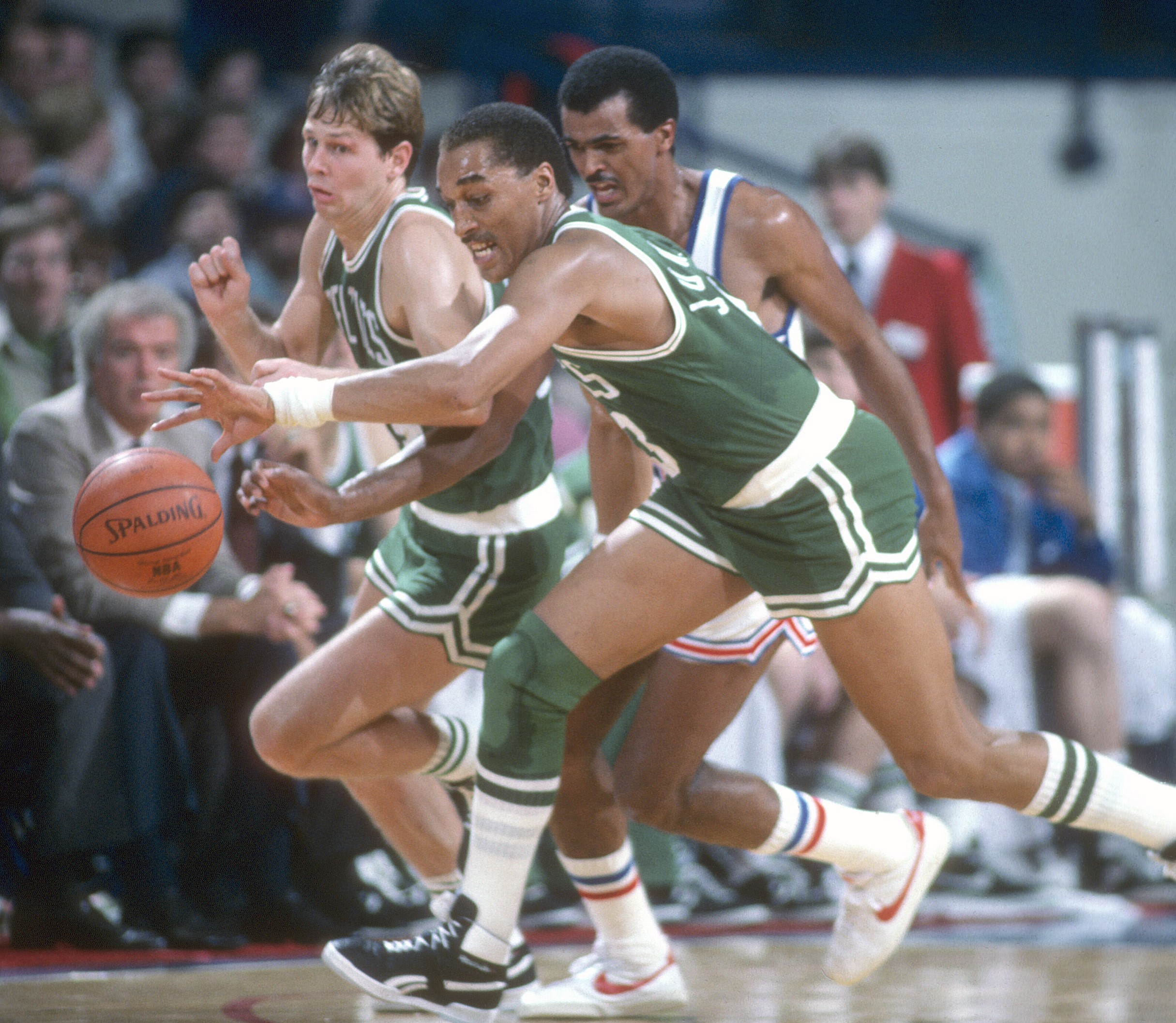 Dennis Johnson of the Boston Celtics chases after a loose ball against the Milwaukee Bucks.