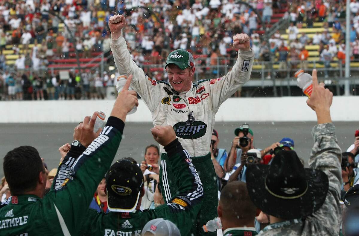 NASCAR driver Dale Earnhardt,Jr. celebrates with his crew in victory lane after winning the NASCAR Sprint Cup Series Lifelock 400 in 2008 | Jonathan Daniel/Getty Images
