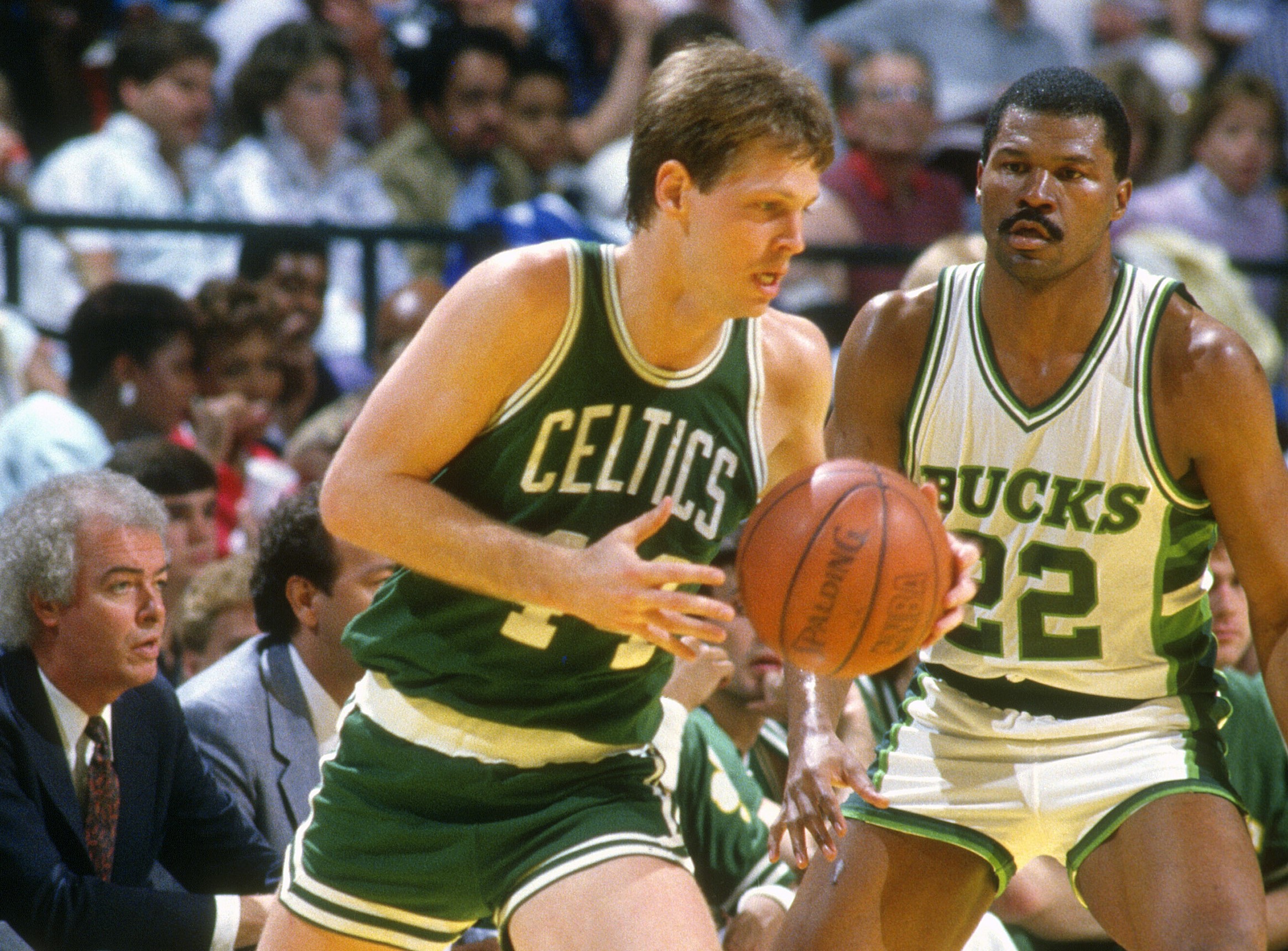 Danny Ainge of the Boston Celtics dribbles the ball while defended by Ricky Pierce of the Milwaukee Bucks.