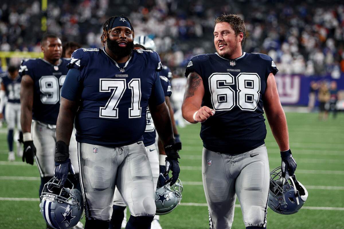 Jason Peters and Matt Farniok of the Dallas Cowboys walk off the field after a game