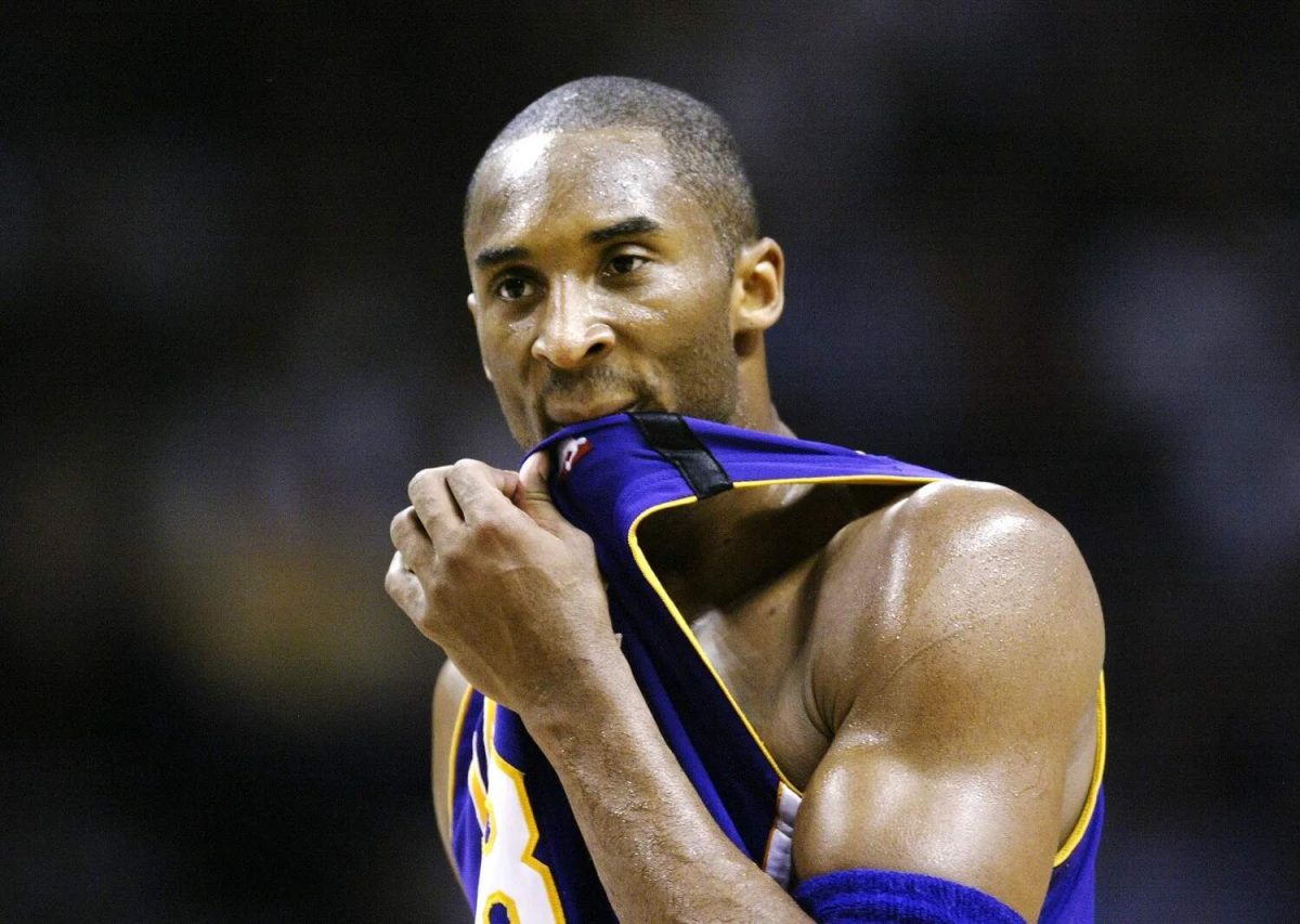 Los Angeles Lakers star Kobe Bryant wipes his mouth with his jersey during an NBA game