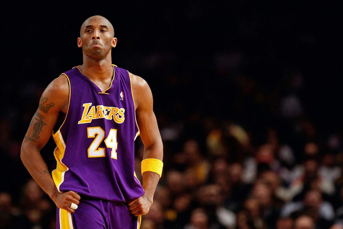 Then-Lakers star Kobe Bryant stands with his hands on his hips during a game