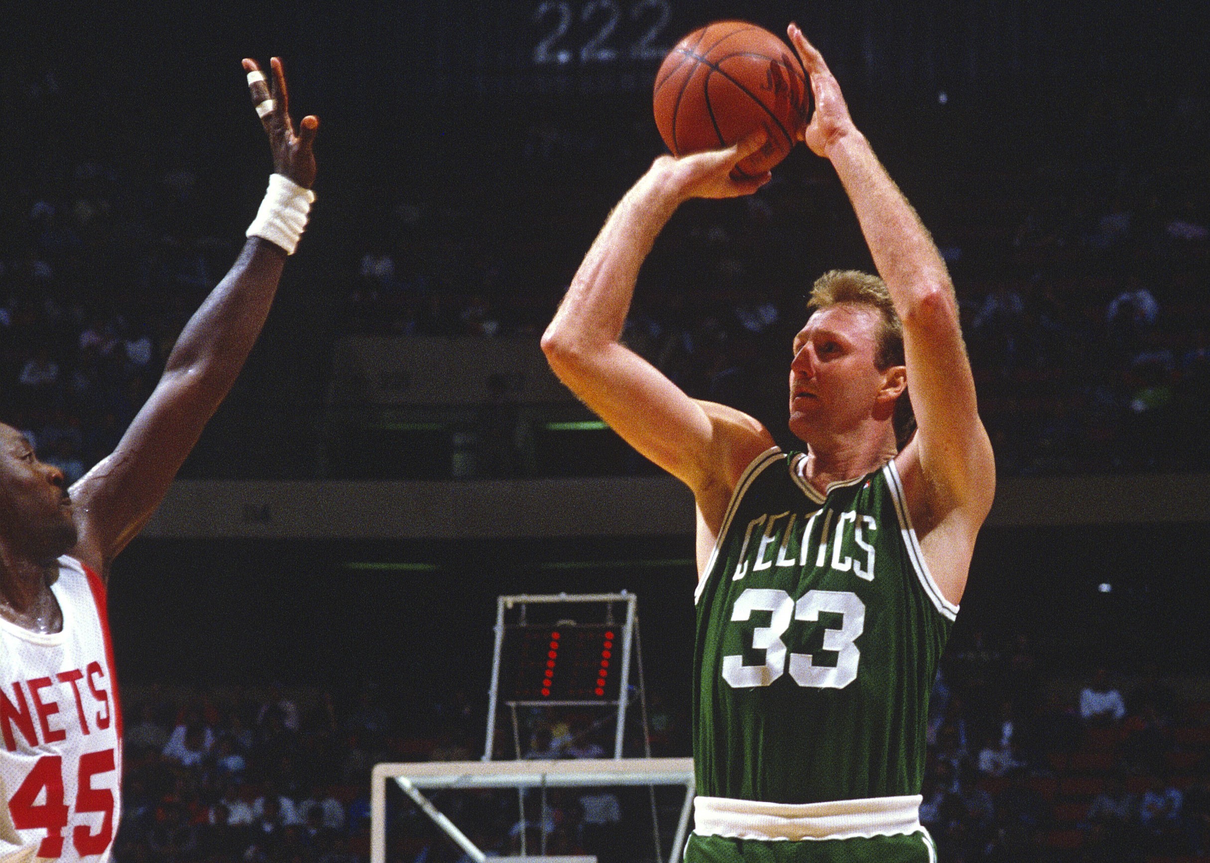 Larry Bird of the Boston Celtics shoot over Purvis Short of the New Jersey Nets.