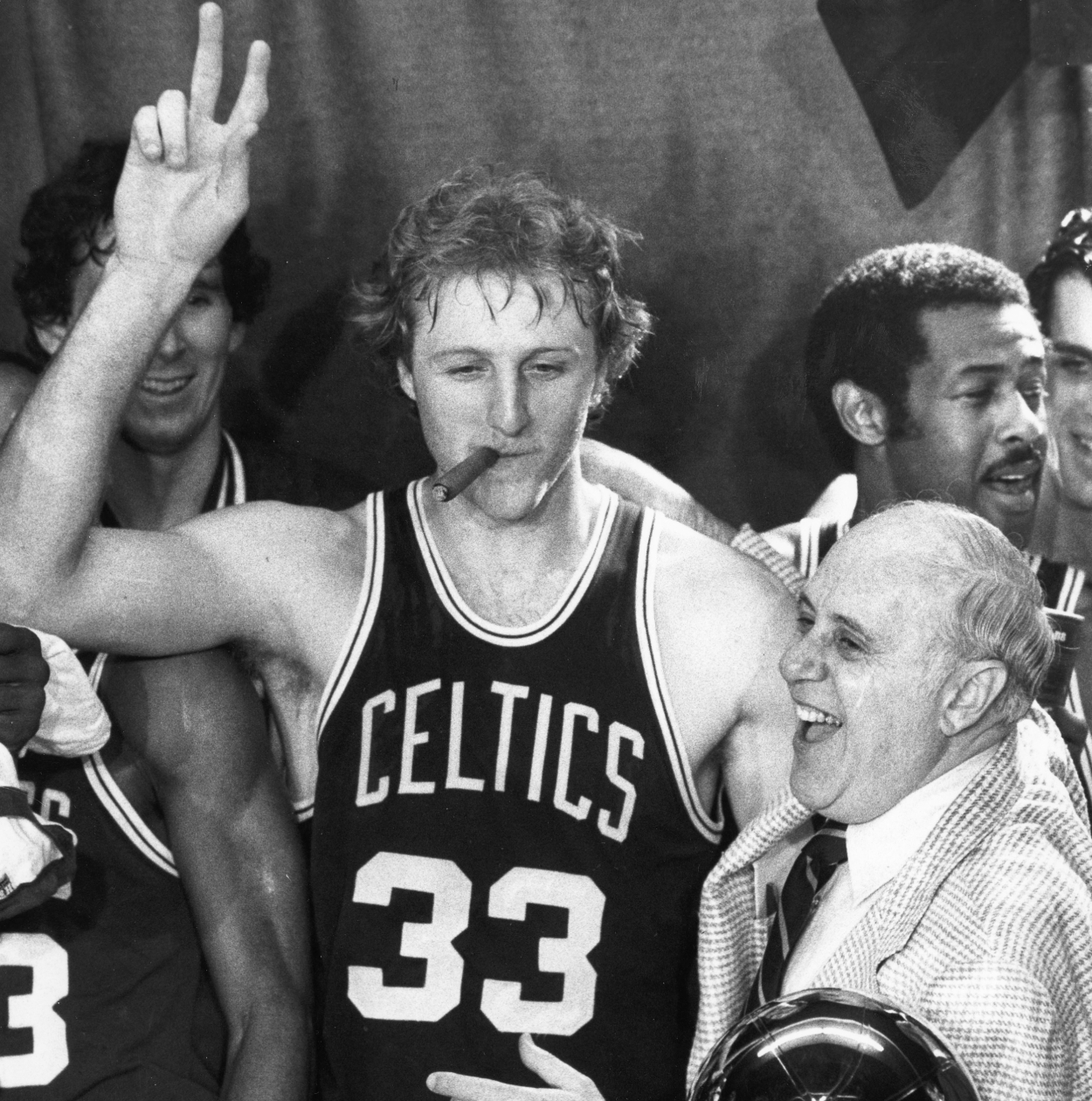 Larry Bird smokes Red Auerbach's cigar after the Boston Celtics had defeated the Houston Rockets to win their 14th NBA World Championship.