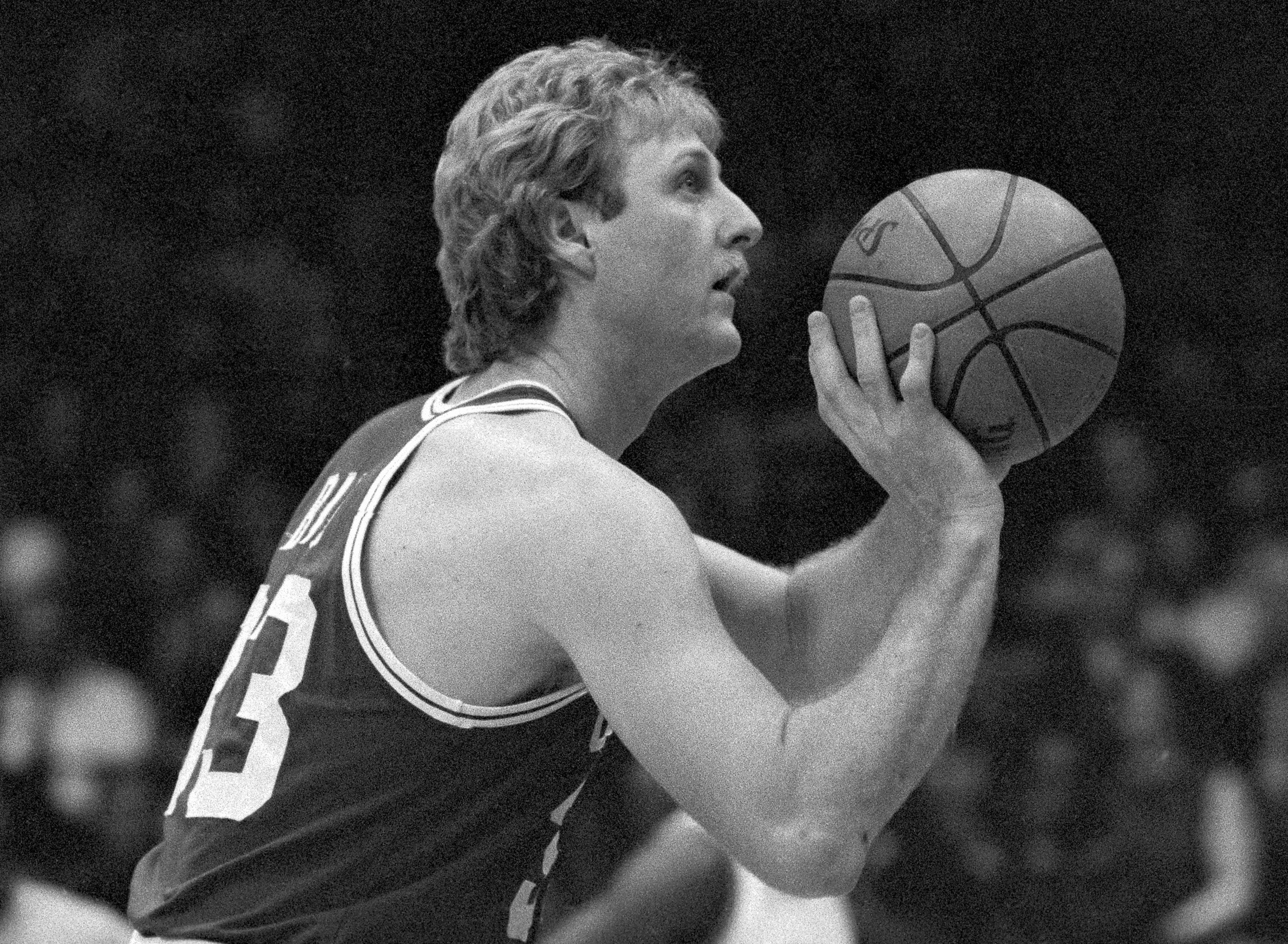 Boston Celtics star Larry Bird takes aim from the line.