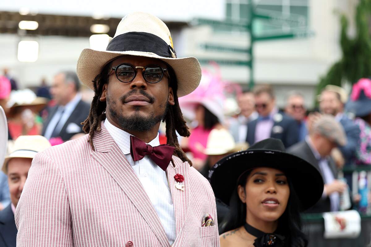 Cam Newton watches an undercard race before the running of the 148th Kentucky Derby