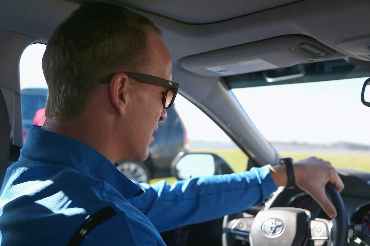 Peyton Manning hops behind the wheel of a NASCAR race car