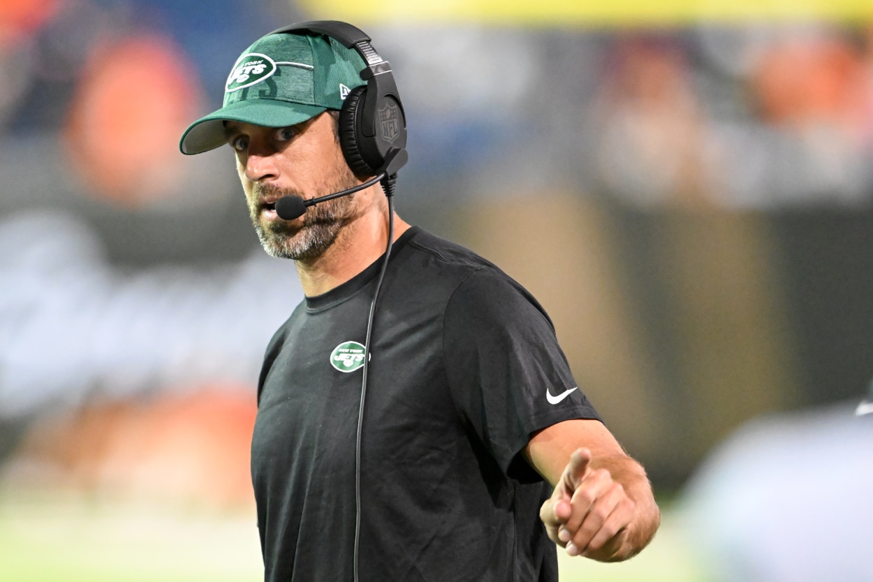 Aaron Rodgers of the New York Jets looks on during a delay in the second half of the 2023 Pro Hall of Fame Game.